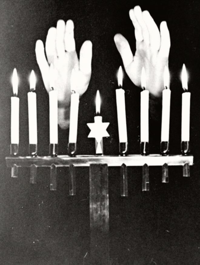 A Jewish woman lighting Hanukkah candles, Germany in the 30’s.