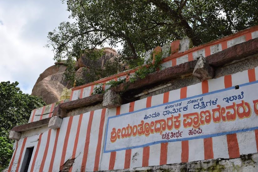The shrine is located on top of a small hillock. The outer walls are painted with white and saffron vertical strips. A flight of steps ends in front of the temple courtyard. In the courtyard a number of snake stones are installed around the foot of a large sacred fig tree.(5)