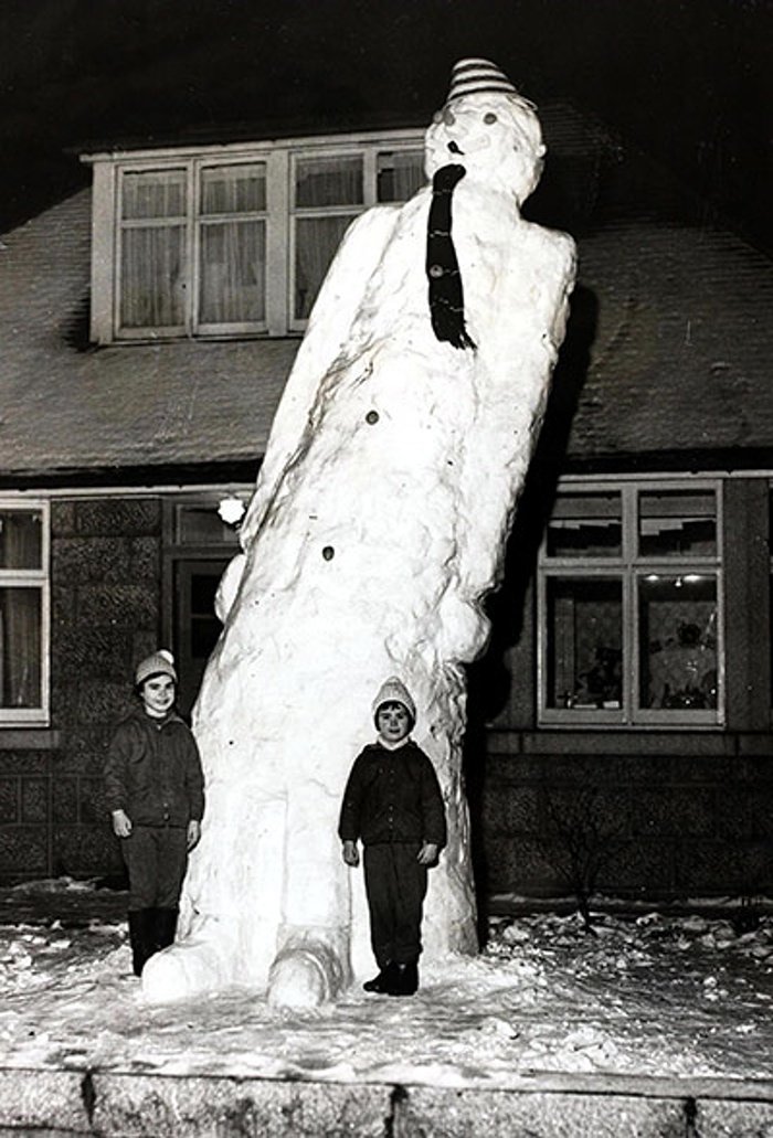 Day 11.The Ghosts of Christmas past  #AdventCalendar.2 girls stand by their 17ft snowman in Aberdeen, Scotland 1962.Photo: Popperfoto