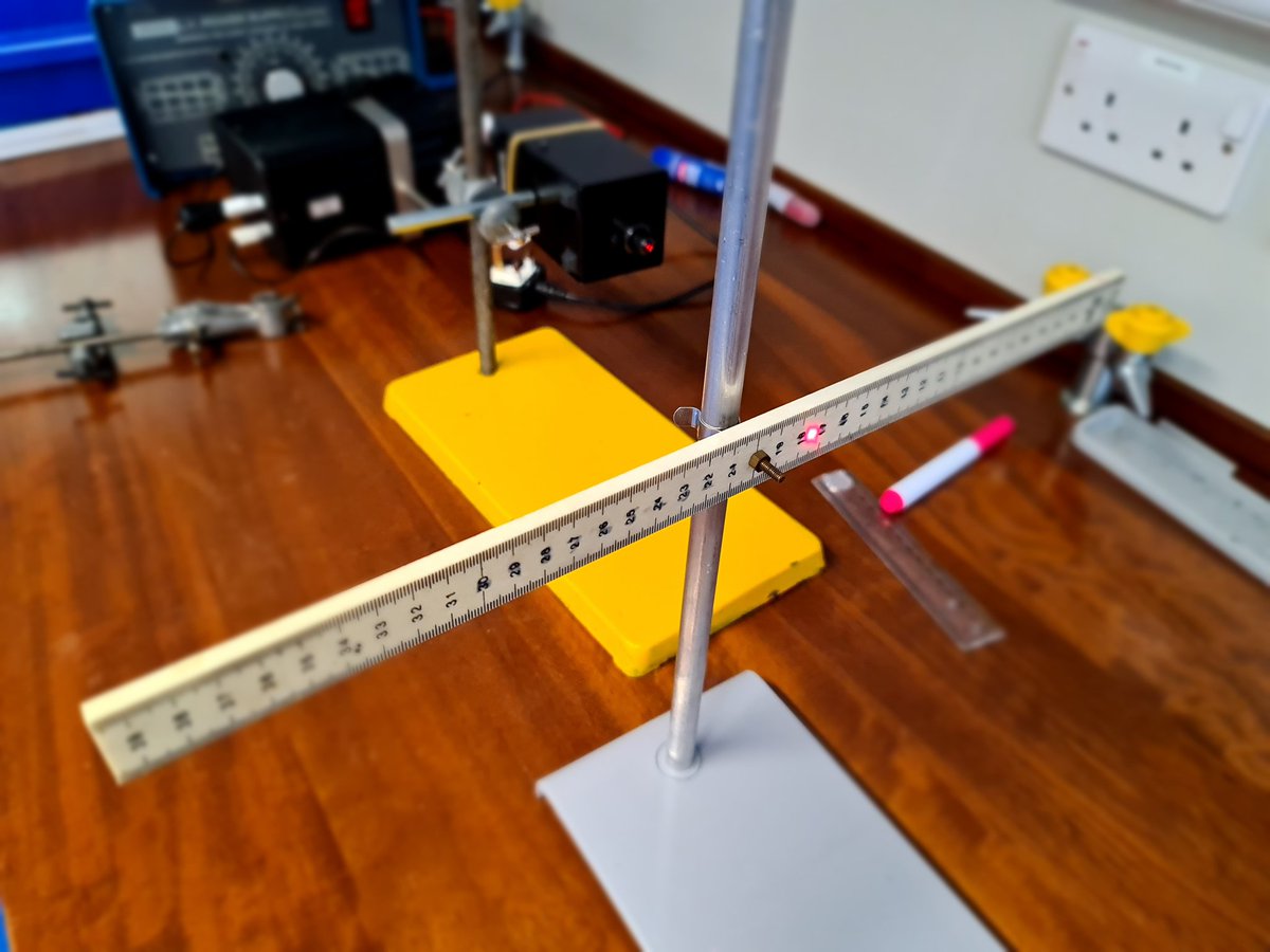 Opposite, we have the laser and a ruler set up to show any deflection of the returning reflected laser beam.