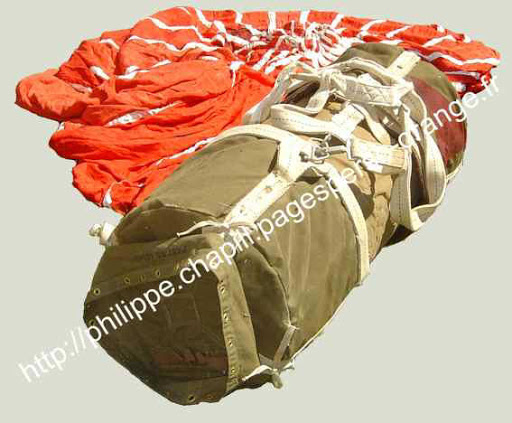photograph but this is one of the best I can find showing the container and what WAS (once) a red cargo parachute. Typically, Red meant Ammunition or Ordnance. These sort of containers were used for deploying .30cal MG's, Bazookas, Mortars etc, but for the Bastogne resupply /6