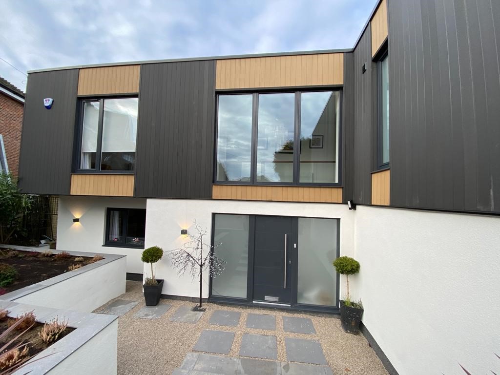 Kömmerling UK anthracite grey tilt &amp; turn windows alongside a smooth grey Kömmerling UK Door composite door.