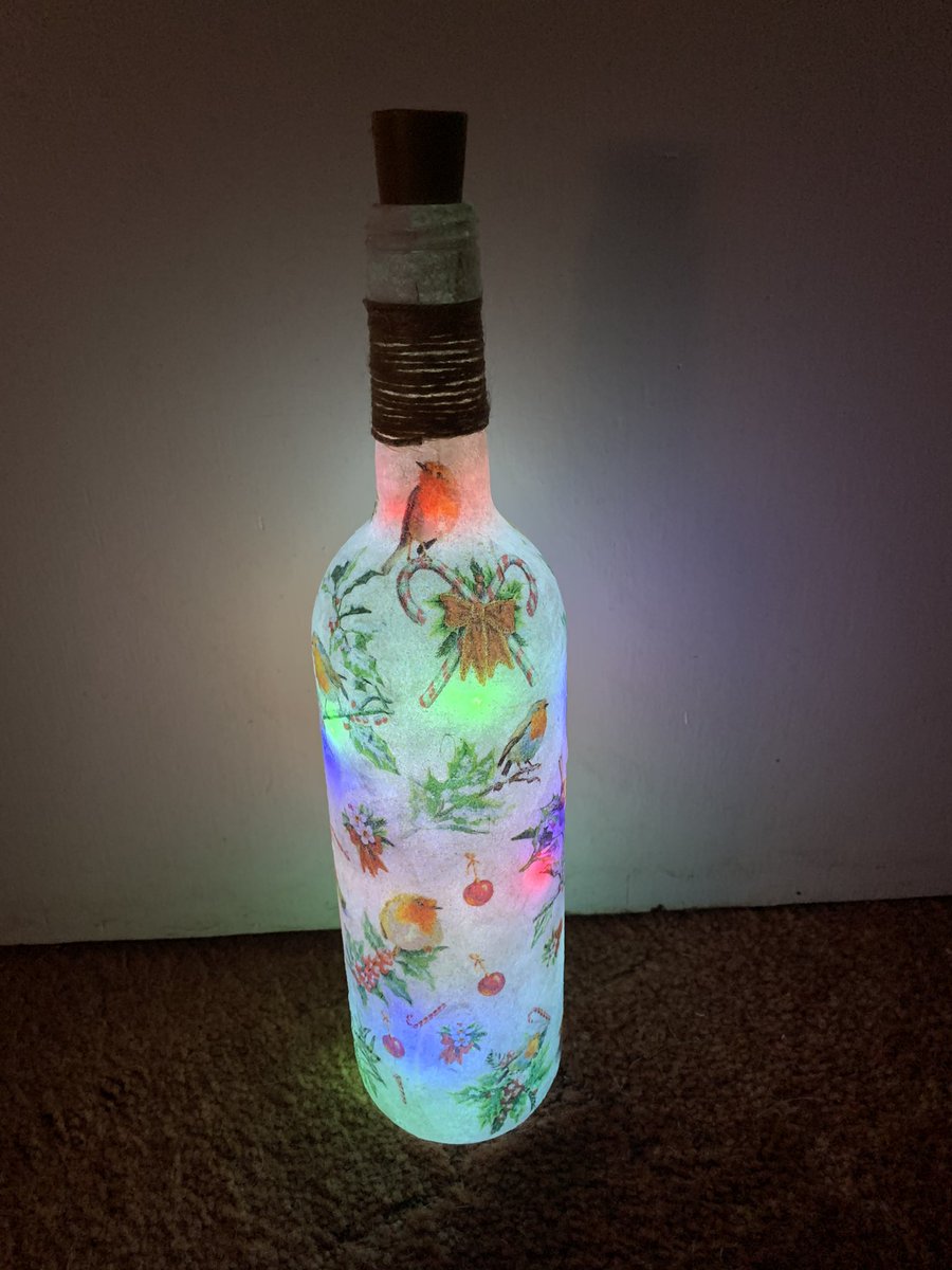 kirstie1971's tweet photo. My first bottle light make. Finished and I’m actually happy with it. Need more clear glass bottles 😁 #craft #decoupage #Christmas2020 #gifts https://t.co/byG4rmotB0