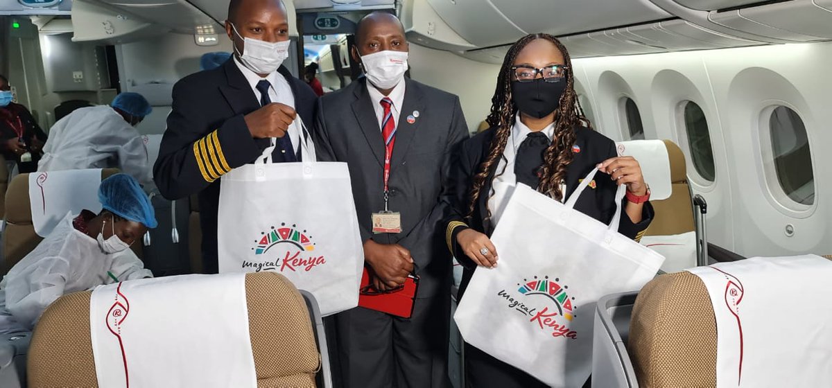 KenyaAirways's tweet photo. Captains @ms_koki and Victor Ngunjiri with Cabin Manager Jason Mose showing that we're all set for the resumption of our nonstop NBO - NYC flight tonight. Thank you @magicalkenya for surprising our passengers with gifts to remind them of our magical country! #KQClearForTakeOff https://t.co/PbM20rlBQ5