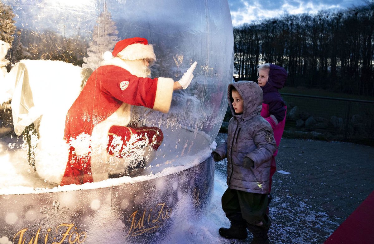 Santa sitting inside a huge bowl of glass 