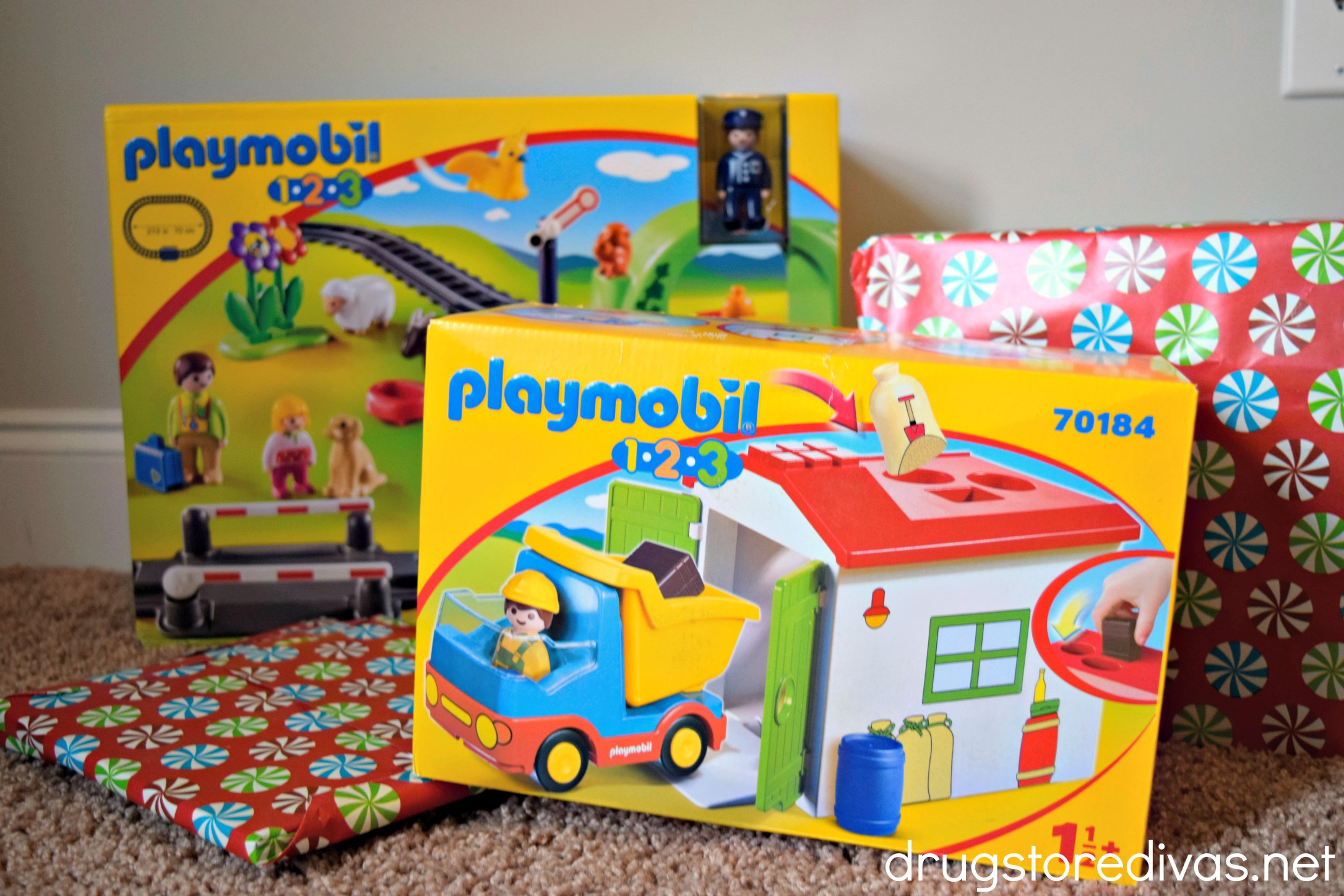 Playmobil toys in front of wrapped presents.