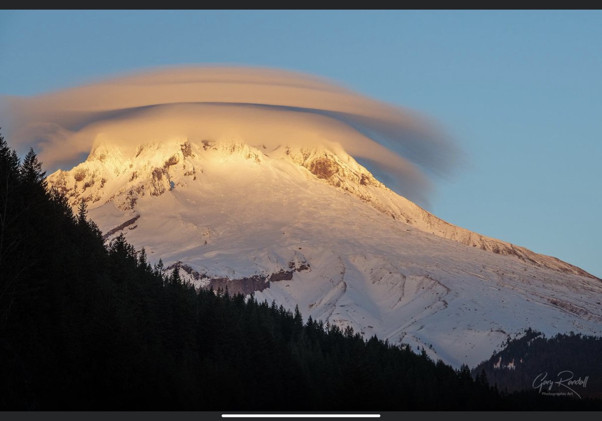 Lenticular clouds over our mountains are not uncommon. This is a great photo of Mt. Hood showing the phenomenon.