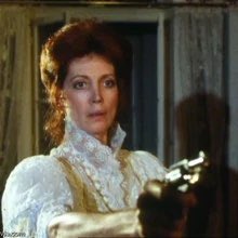 this instantly tells us (as if the set, with its paintings and furniture, as well as the appearance of some sort of butler or other male servant, didn't already) that irene adler is well-off. the sheer amount of lace would put this garment out of reach for a working class woman.