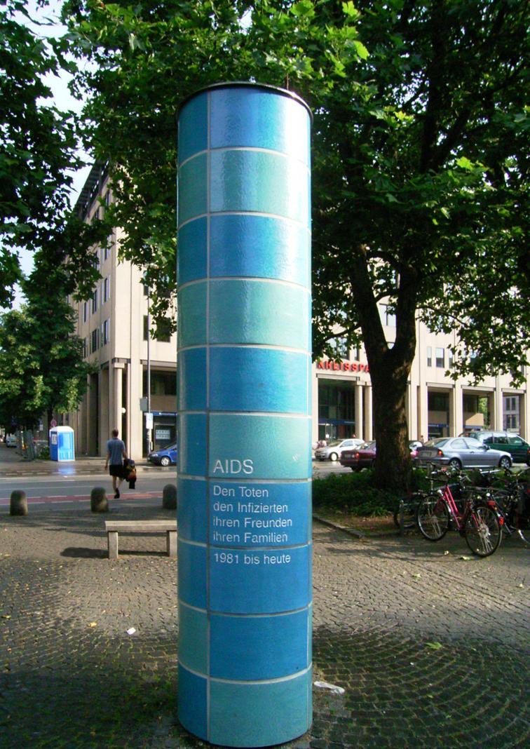 In my own hometown of Munich, Germany, the AIDS Säule (column) stands in the city center on Sendlinger Tor Platz, often going unnoticed by passers-by. Dedicated in 2002, it‘s styled like the columns in the underground station below, symbolizing an unearthing of the unseen.