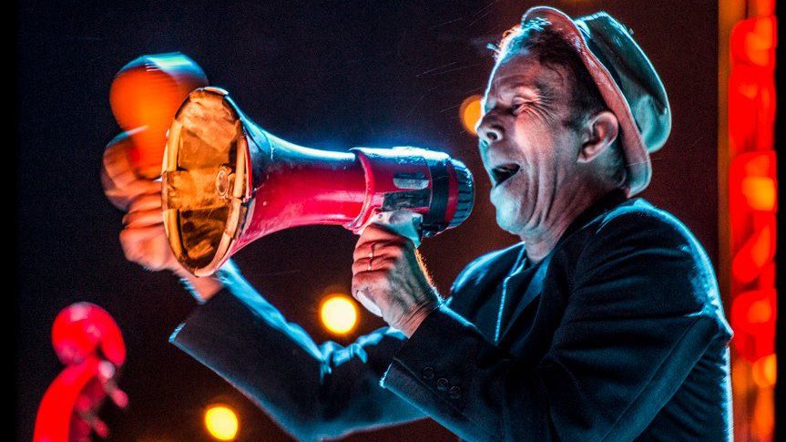 Tom Waits said this on his use of a Bullhorn:“I'd never sung thru a bullhorn. I'd tried to get that effect in other ways. I tried cupping my hands, singing into tin cans, using those 7-dollar harmonica, singing into pipes & there it was. A battery-operated bullhorn.”