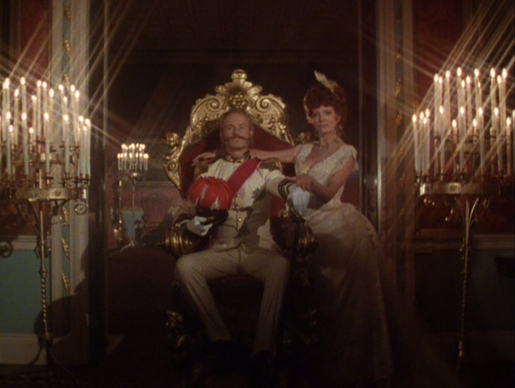 the train from her hat conceals the skirt, but she clearly doesn't have a bustle in this scene. but in other flashbacks, i thought she did. looking again, i think it was the way the fabric flared out while dancing that gave the illusion of a larger bustle: