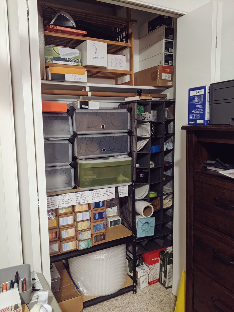 The closet is mostly a series of shoe organizers I have repurposed in various ways. Hanging ones for storing tape, stamps, or other goodies.Wooden ones up top for holding boxes of envelopes or other large things.Plastic modular ones with doors for storing polybags and boxes.