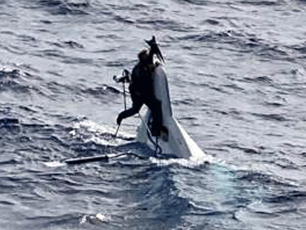 Lost sailor found desperately clinging to capsized boat and rescued just before it sank