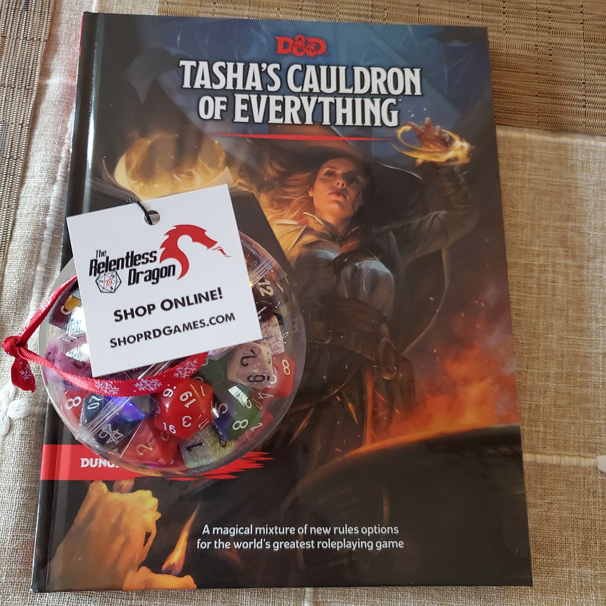 dnd4awesome's tweet photo. Stopped by Relentless Dragon game shop in Nashua NH last week and picked up the physical copy of Tasha's and found a great dice ornament!    Remember to keep supporting those local game shops! https://t.co/13ssA8fhmj