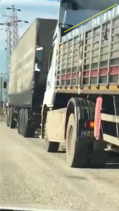 Only the cargo of the rear truck is visible, but it clearly carries stacks of small containers matching those seen in yesterday's video of the Afrin olive oil facility. (6/10)