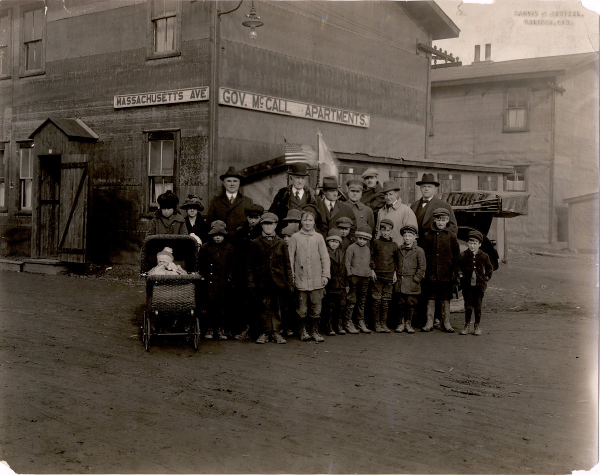 As Halifax struggled to recover, Boston continued to send aid workers, supplies, and funds. This photo shows Gov McCall and aid workers w/ Halifax families in front of an apartment complex built by aid workers. This apartment building sheltered nearly 320 families, or 2k people.