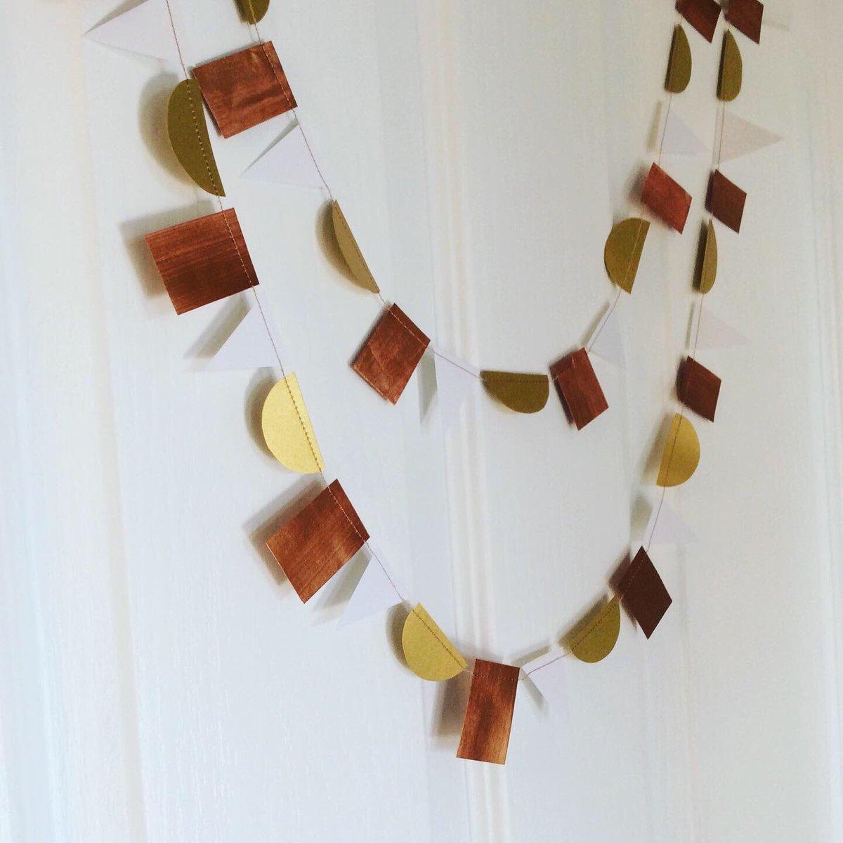buntingdisrupt's tweet photo. These paper garlands are my best sellers at the moment - stars, hearts and geometric shapes... #HandmadeHour #handmadeChristmas #shopsmall https://t.co/e7qIokVyY8 https://t.co/O0AayAX4Yr