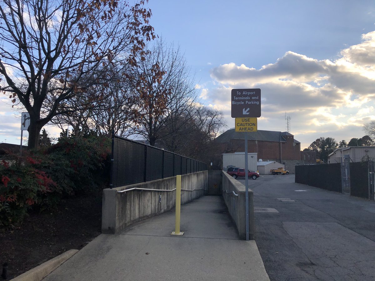 From there, you will ride through a small service parking lot. Follow the trail and signs here towards “Bike Parking.”