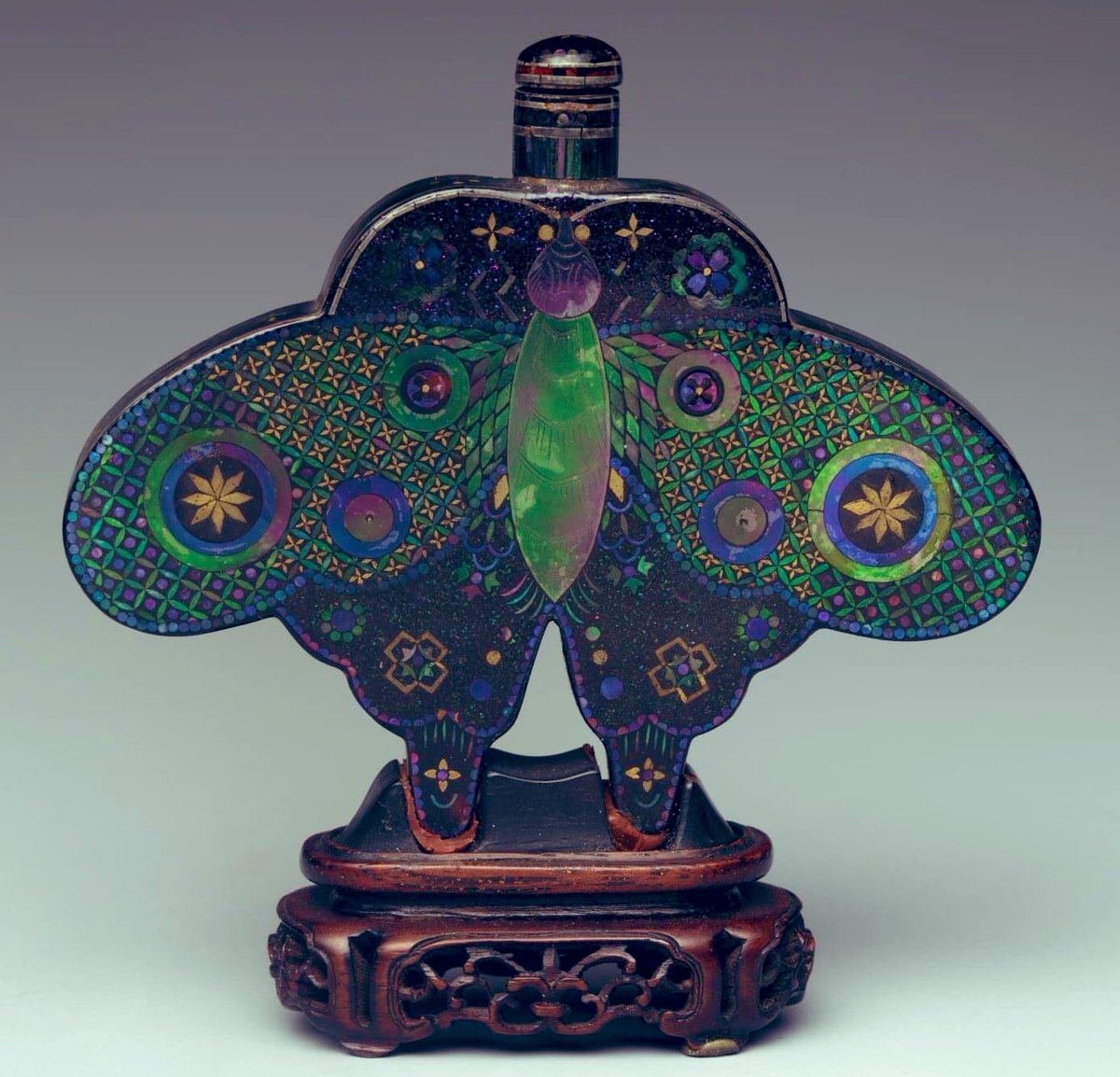 Late Qing Dynasty (1644-1911) butterfly-shaped snuff bottle. Metal covered with lacquer, inlaid with mother-of-pearl and gold. The butterfly is cherished for its beauty and is associated with joy and delight, in Chinese art.
