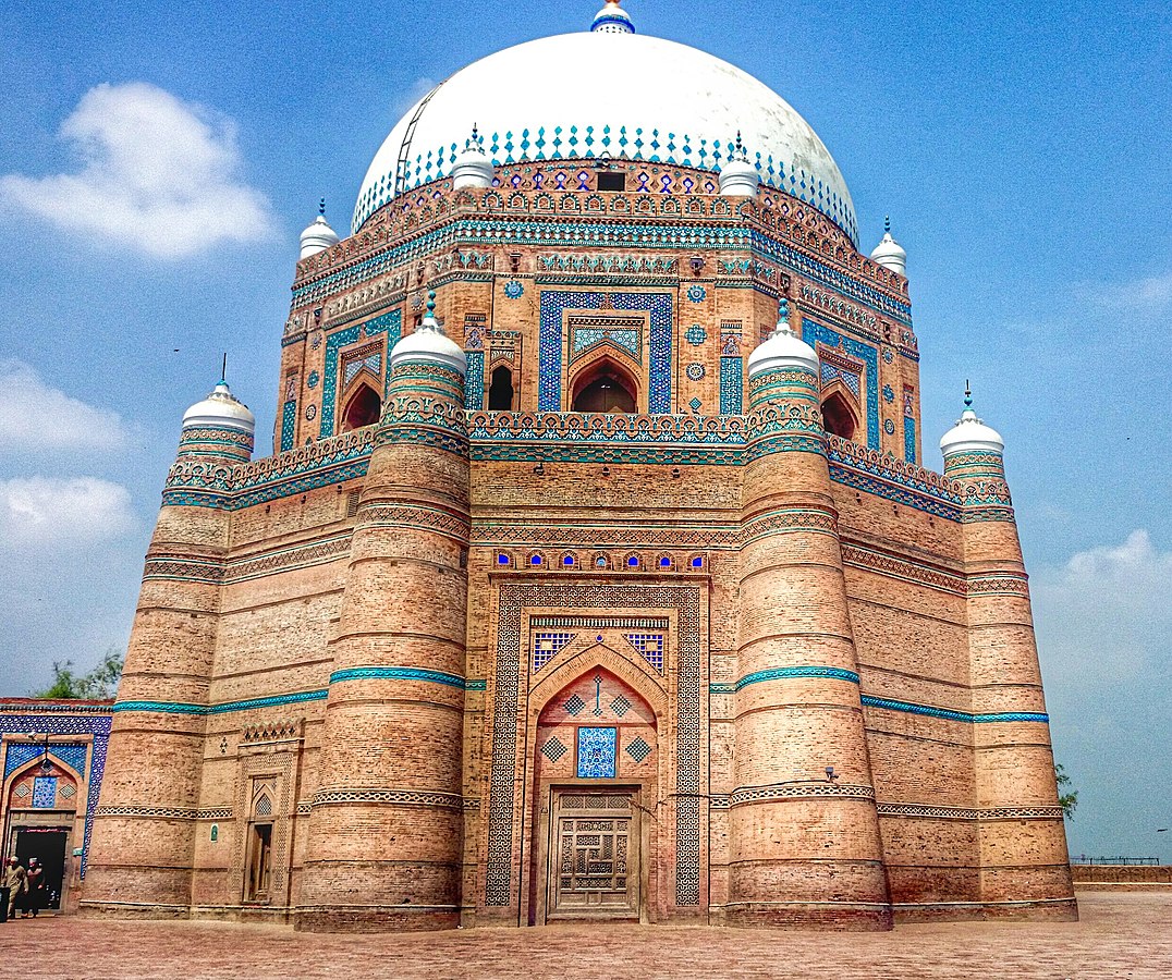 One can almost see the evolution of the walls of the tomb, from the more militaristic style of the tomb at Kabirwal built in the 1100s to the Tomb of Shah Rukn-e-Alam in 1300s.The crenelated bastions at Kabirwala get capped by domes to become elegant towers at Multan.  https://twitter.com/WasaibExplor/status/1334360531226935296