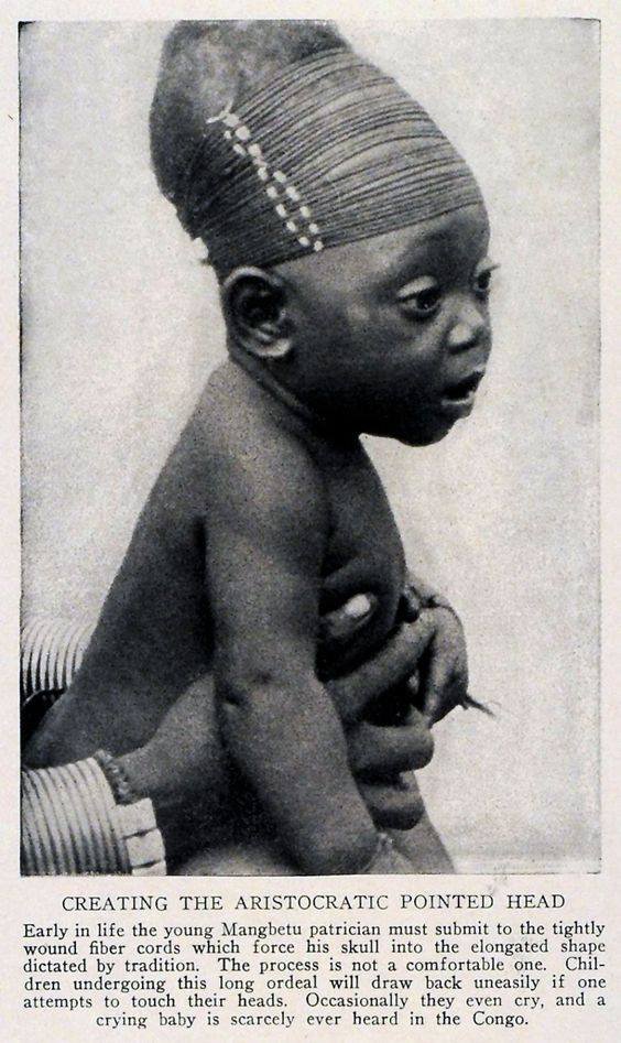 Africa | Creating the Aristocratic Pointed Head | Baby Mangbetu Skull Shaping. Congo | 1929 Print