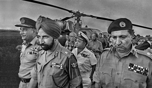 December 16, 1971 was a historic day. Lt. Gen Jacobs went to the airport to receive General Aurora. There was an entourage with him, which included his wife, and they drove straight to the racecourse where the surrender ceremony was organized. He was given a guard of honour by+