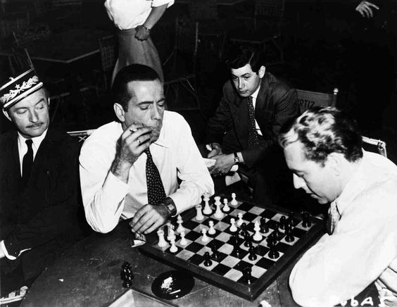 Bogie played on movie sets for years (photo below during the filming of Casablanca). His famous opponents included friend and fellow actor Theodore Bikel (they tried playing a blindfolded game) and chess master Samuel Reshevsky (Bogart played him to a draw).  #chess