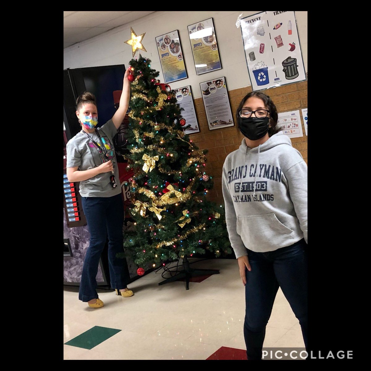 Two people by Christmas tree.