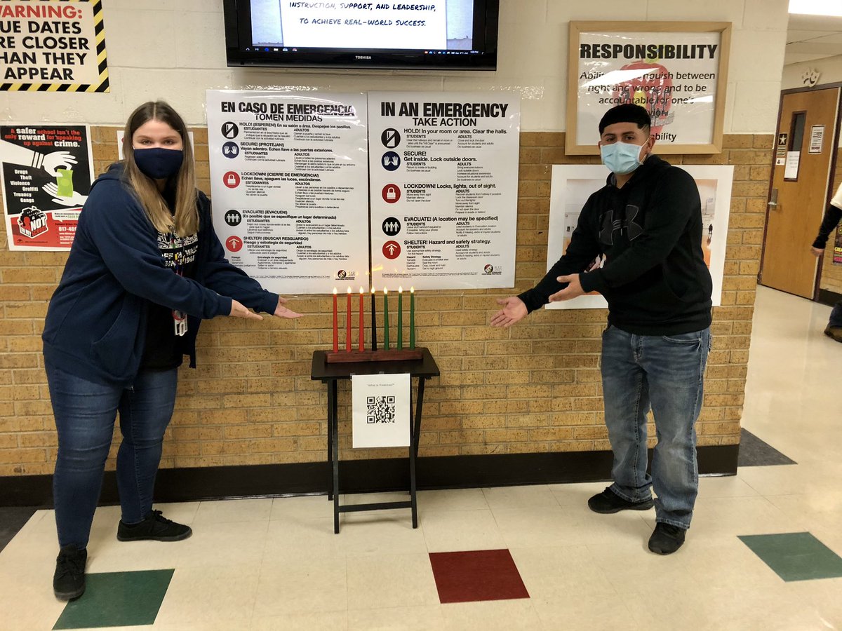 Two people by candle dreidels.