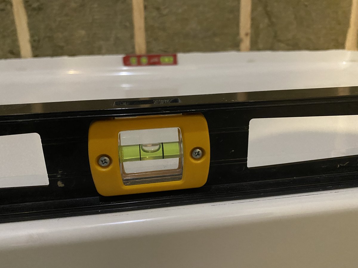 Close up photo of a level bubble to show the leveled shower base