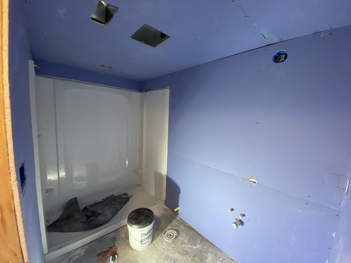 Same photo as the original tweet showing the shower kit standing in a now partially-finished room