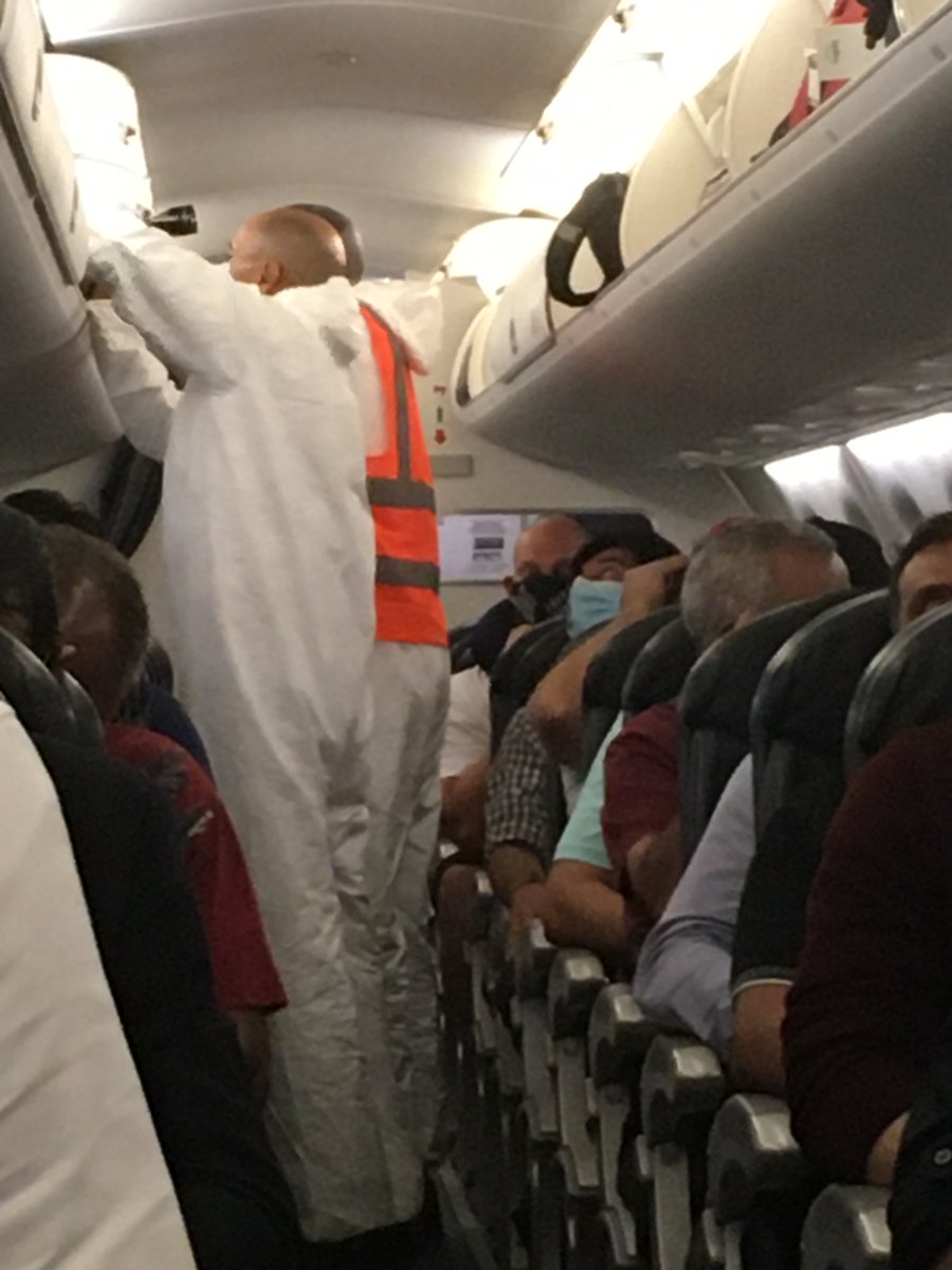 Airline and airport personnel wore disposable plastic biosecurity coveralls over their clothes- no one here is messing around.