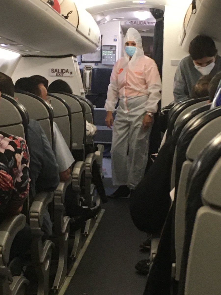Airline and airport personnel wore disposable plastic biosecurity coveralls over their clothes- no one here is messing around.