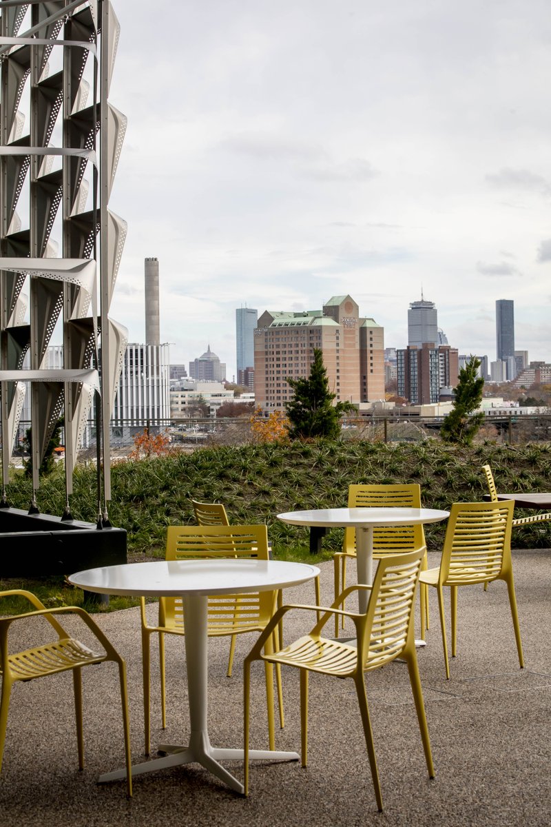 Tables and chairs outside with a view of Boston