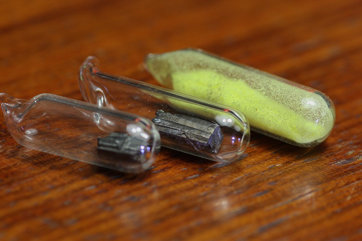 Uranium  #elementphotos. Yellow powder is uranyl acetate (UO2(O2CCH3)2.2H2O). Green glass contains uranium salts doped into the glass to make it fluoresce in UV light.