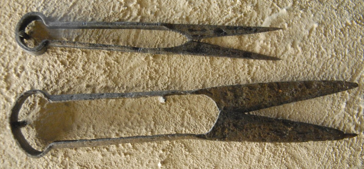 JulyMore work on the land, I've cut my finger on a scythe, they're bloody dangerous, imagine using one in a time before antibiotics...The sheep are being sheared.The man's clothing has seen better times, a woman helps.Some medieval wool scissors from a museum in Russia.