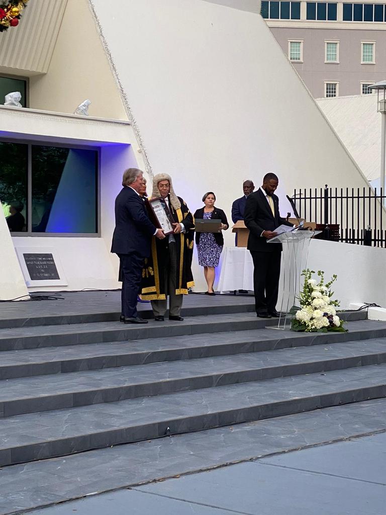 moseskMLA's tweet photo. The House of Parliament officially opened. The Hon. Deputy Premier receives a Symbolic Caymannite key to the House of Parliament, the key was commissioned by local artisan Horacio Esteban and a commerative painting commissioned by local artist Gordon Solomon. https://t.co/r4m98WChke