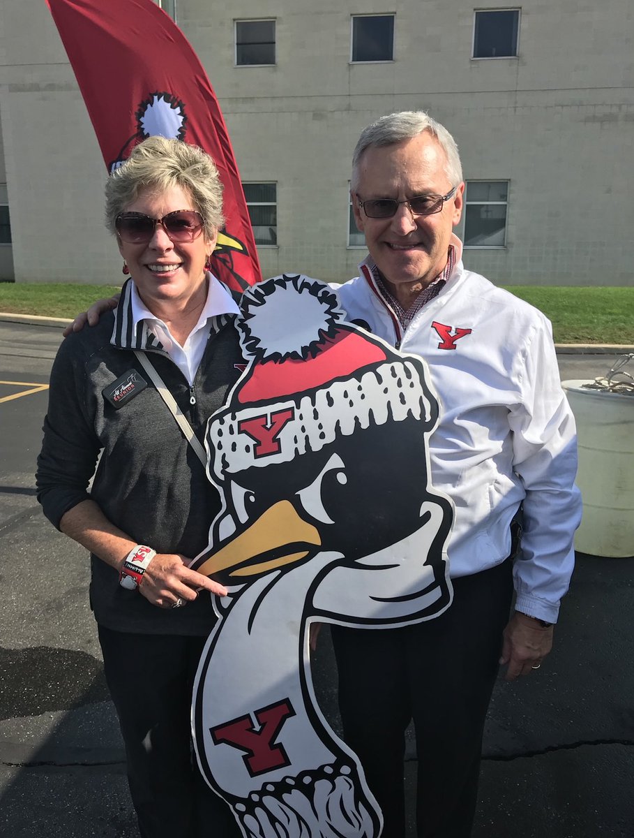 Ellen and Jim Tressel pose outside with a Pete the Penguin cardboard cutout.