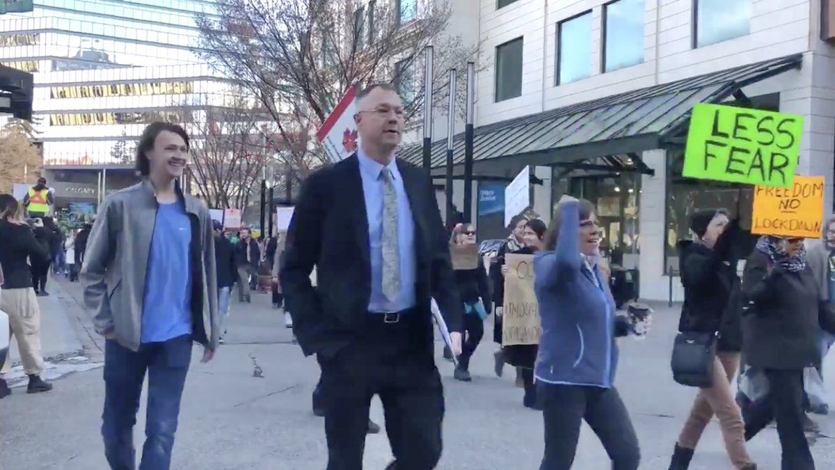 . @robbpettit noticed someone walking past the camera at about 0:10 who appears to be John Carpay. Maybe Carpay knows who’s helping to finance this operation? #ableg  #covidiots  #spreadnecks