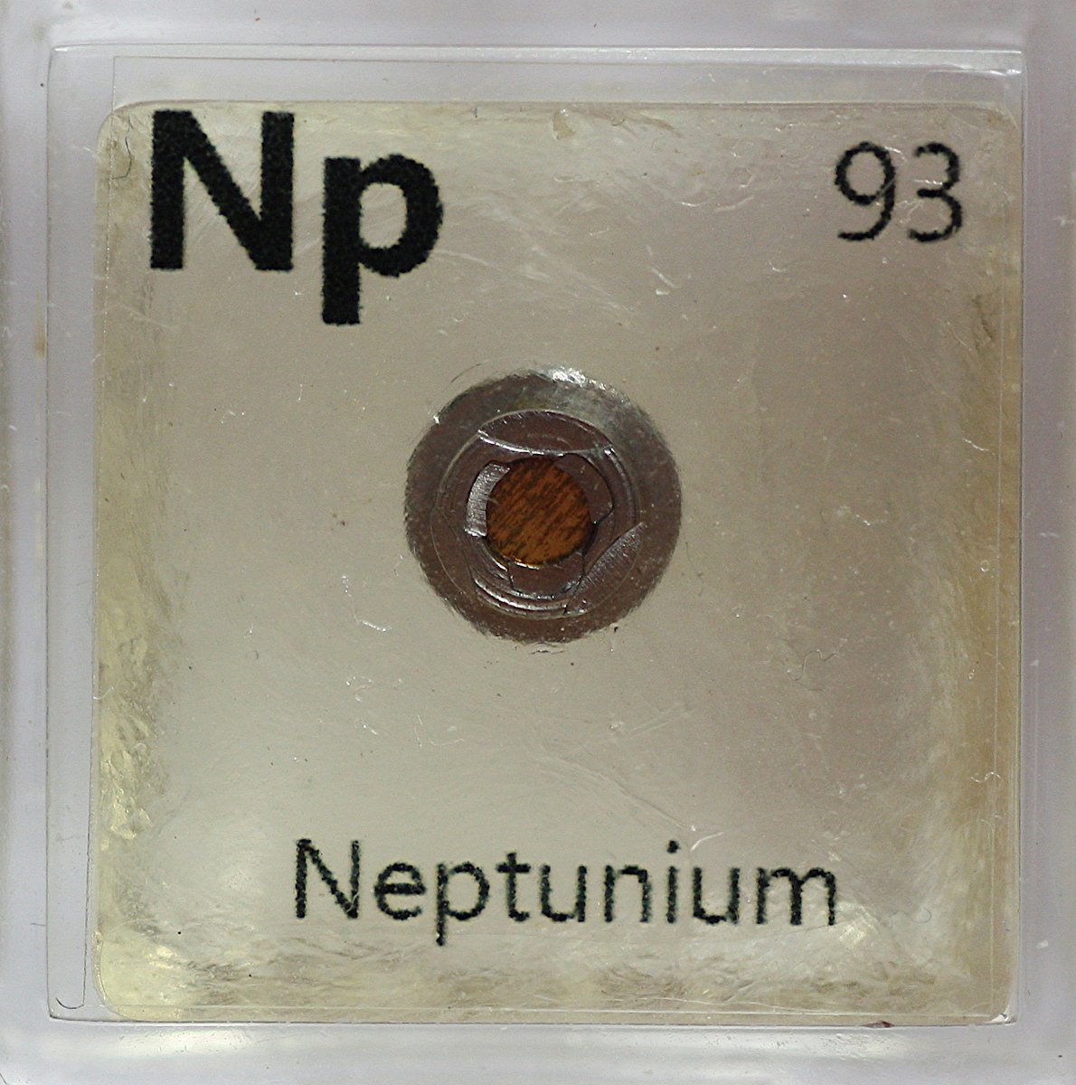 Neptunium and Americium  #elementphotos. At the heart of an ionisation-type smoke detector is a little button that contains a small amount of americium dioxide (AmO2). The Am241 (halflife 432 yrs) decays to Np-237 (halflife 2M yrs), and thus the Am is slowly being replace by Np.