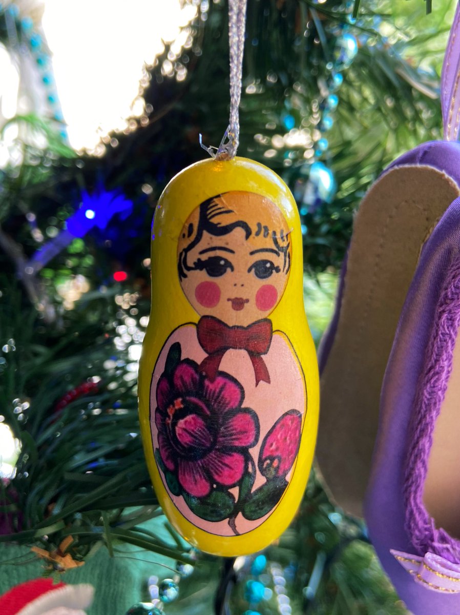 I have two of these little wooden matryoshka dolls. (Purple ballet slippers from Paris in the background.)