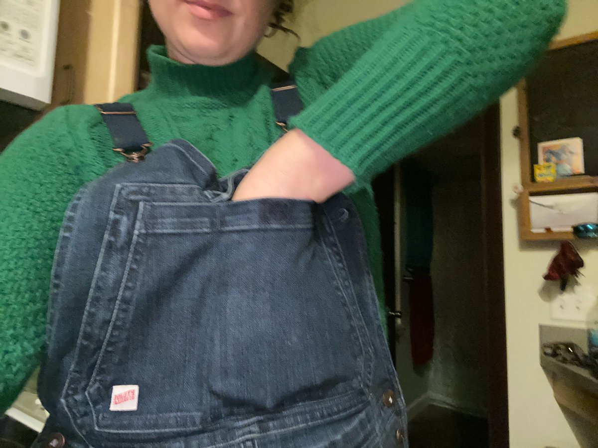 One, the smaller one, is open. The larger, has the flap. Here they are. My whole hand, with fingers half-spread, in the big pocket. Two to three fingers in the other, and I can’t reach the bottom. Good for longer items... candy bars, for example.