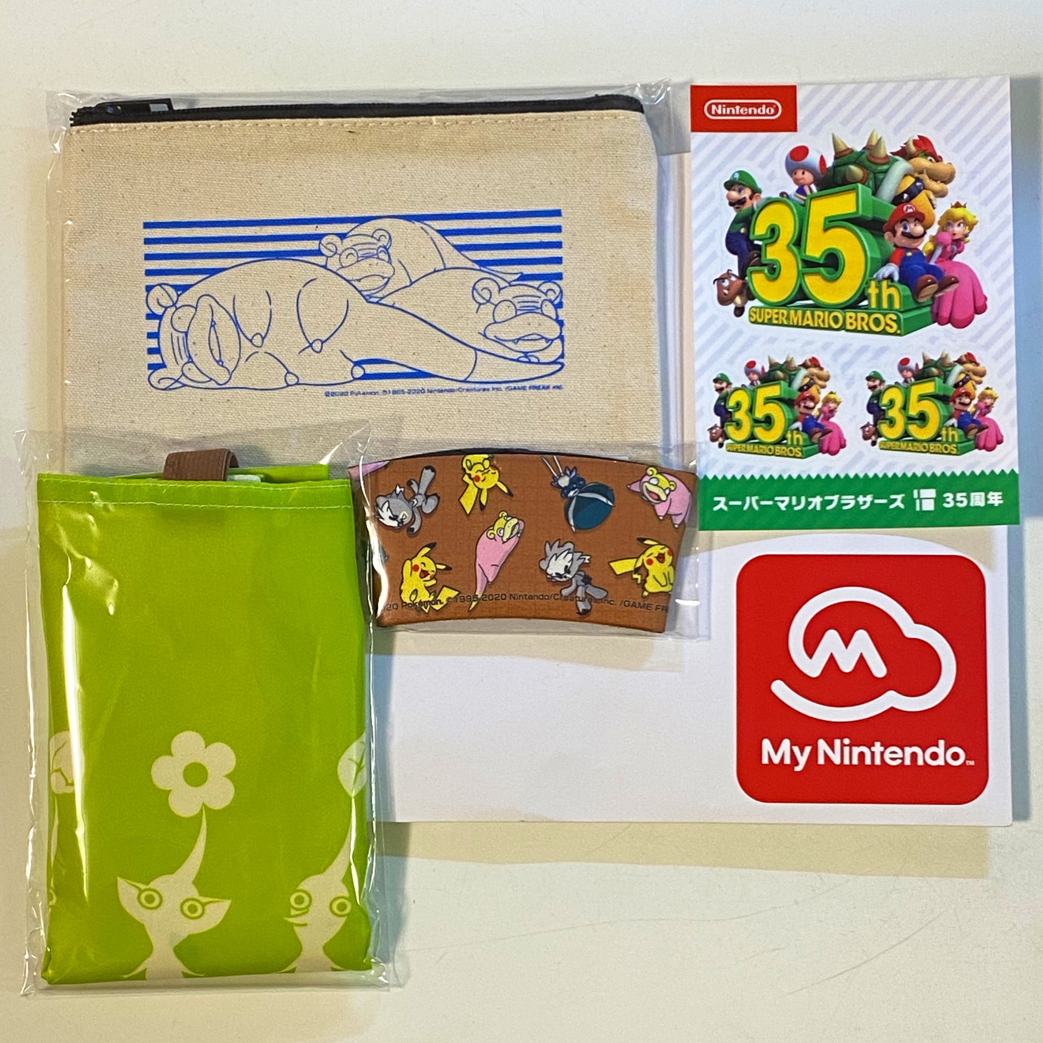 白樺太郎 My Nintendo Storeのプラチナポイントの引き換えたポケモンのカップスリーブとヤドンのキャンパスポーチ そしてピクミンのエコバッグが届いた 35周年ステッカーも入ってた T Co Uoexkilzi3 Twitter