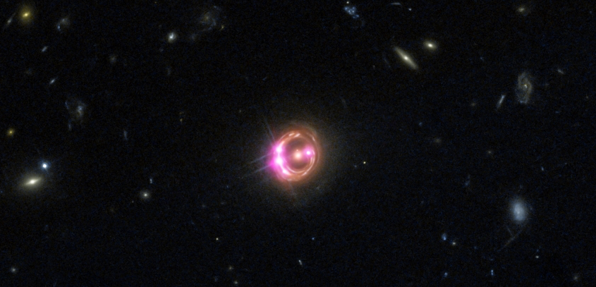 The quasar in the center of this image, which is based on data captured by NASA’s Chandra X-ray Observatory and the Hubble Space Telescope, contains the supermassive black hole known as RXJ-1311.
