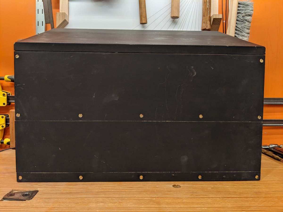 The bottom compartment of most dutch tool chests has a door that is held in place with a wooden lock mechanism (which eats up more space than I can sacrifice) that is accessed from the top compartment. The top compartment then has a metal lock installed to secure everything.