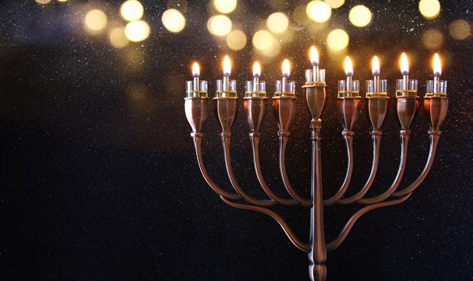 an additional candle is lit, so all eight are burning on the final night. Families and friends will often gather and recite traditional blessings or sing songs together as they light the menorah. The menorah we put next the window, where it was placed it in Talmudic times.