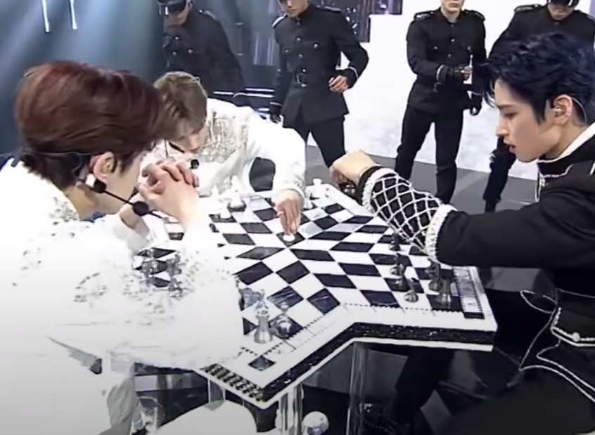 were the royals and they had the three person chess board in their checkmate performance, which could be a hint to the three contestants of kingdom. the goal of chess is of course to win, but you win by taking out the other person’s king (ie the crown used as a central piece)