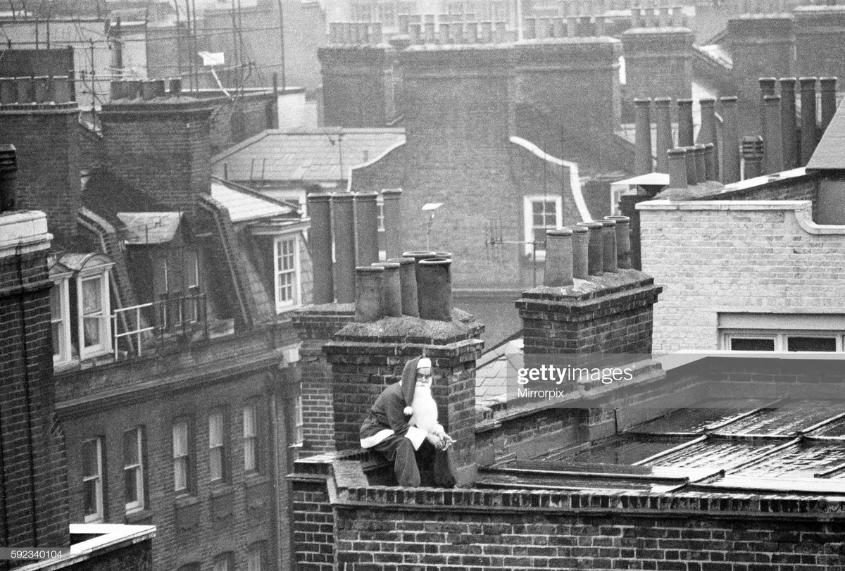 Day 7.The Ghosts of Christmas past  #AdventCalendar.Santa takes time out from his busy schedule for a cigarette break on the roof of a building in London's West End, 23rd December 1970. Photo Daily Mirror/Mirrorpix