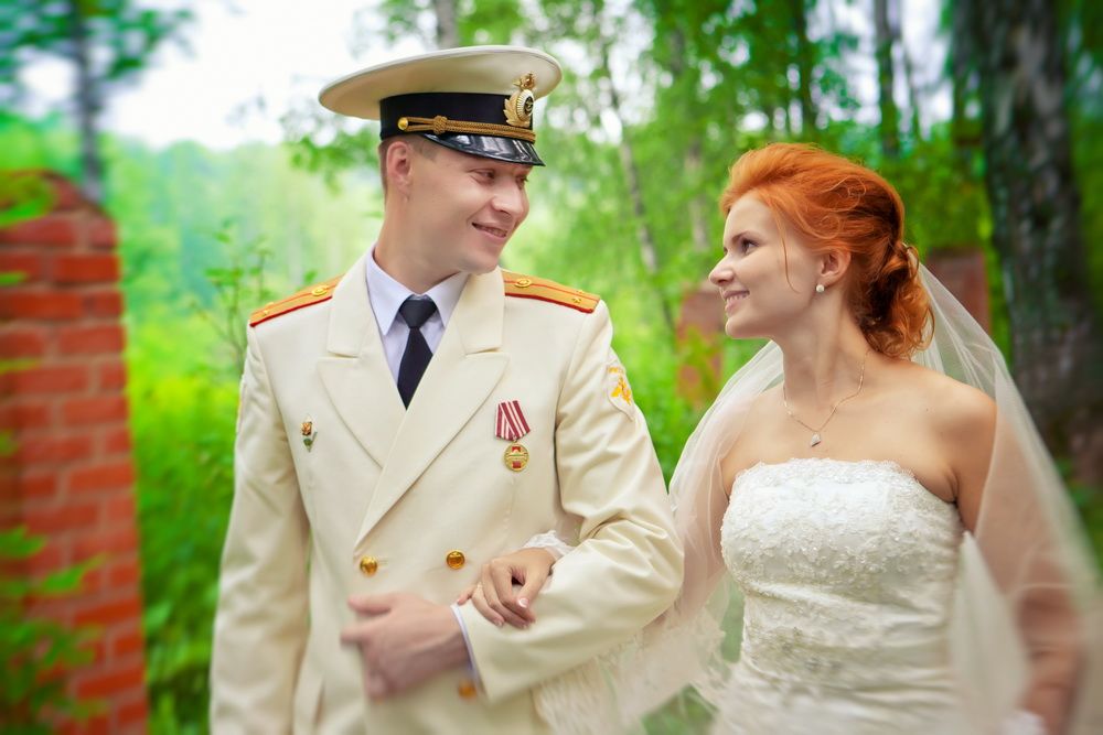 Slim and with Blonde Hair and Sparkling Blue Eyes. She Was Very Beautiful Indeed. The Boy Was almost the Same Age and Very Handsome. He Was in a Military Uniform The Girl was Holding a Bouquet and the Two Were Standing with Their Arms Linked