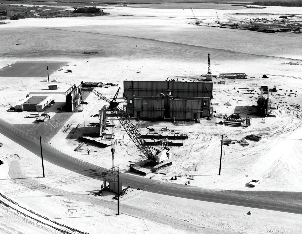 The first MLP began construction in July of 1963. The first image here is from late 1963 shows the construction areas just north of the VAB site for MLPs 1 & 2. The second image is a closer look at one of the MLPs in early 1964.